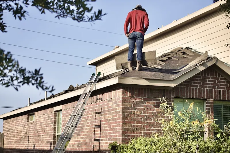 Professional roofer working on a residential roof in Woodbridge Oaks
